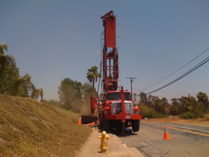 Air Percussion drill rig on side of the road