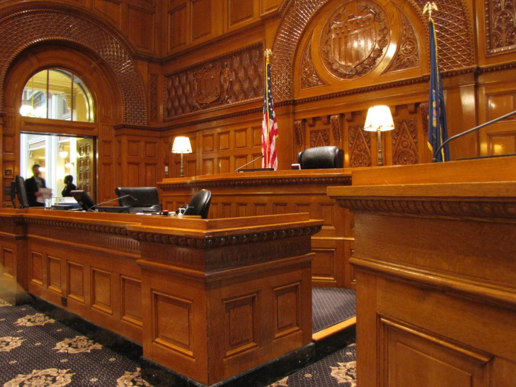 judge’s bench and witness stand in courtroom
